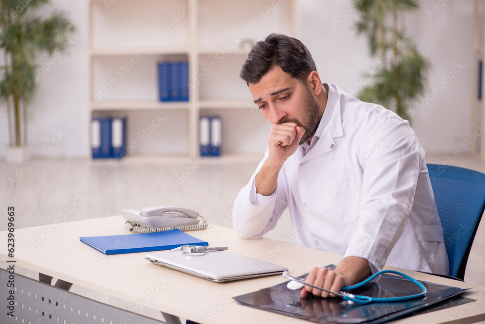 Young male doctor working in the clinic Young male doctor working in the clinic
