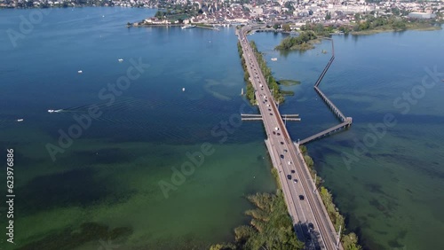Rapperswil, Switzerland: Aerial drone footage of the bridge over Lake Zurich toward the rapperswil-Jona city in canton Saint Gallen on the sunny summer day with a tilt up motion.  photo