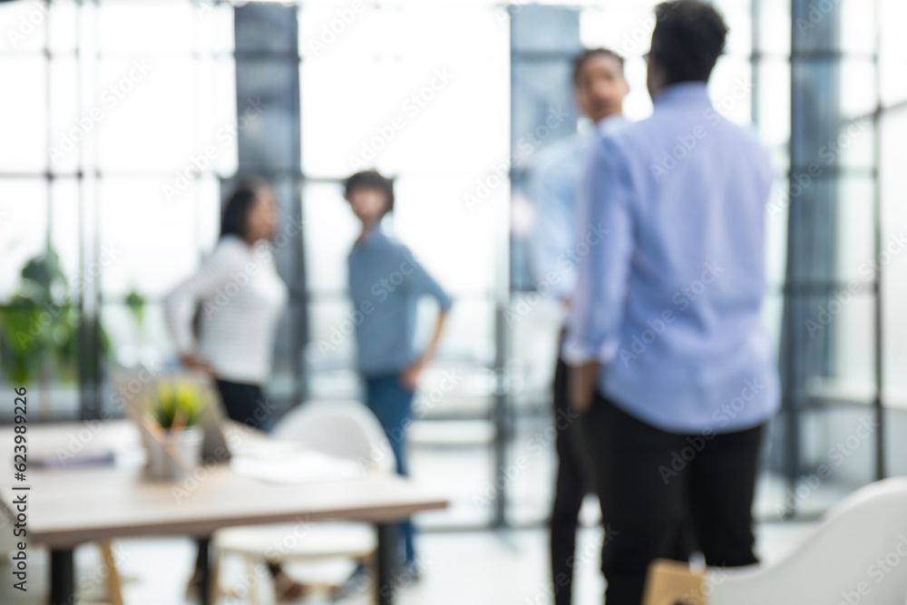 Blurred image of business people standing in the office Blurred image of business people standing in the office