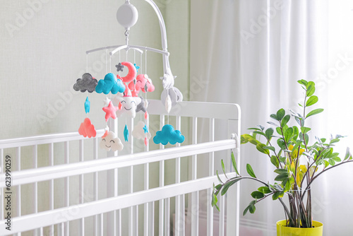 Toys above the baby crib. Baby crib mobile with stars, clouds and moon