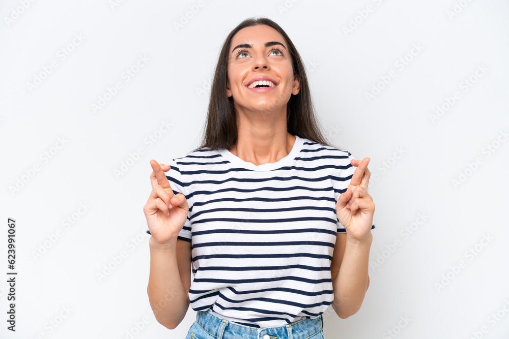 Young caucasian woman isolated on white background with fingers crossing and wishing the best Young caucasian woman isolated on white background with fingers crossing and wishing the best