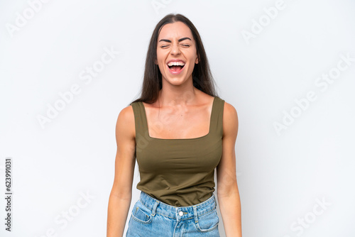 Young caucasian woman isolated on white background shouting to the front with mouth wide open © luismolinero