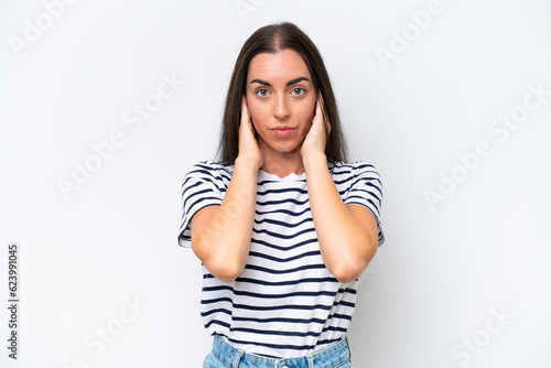 Young caucasian woman isolated on white background frustrated and covering ears