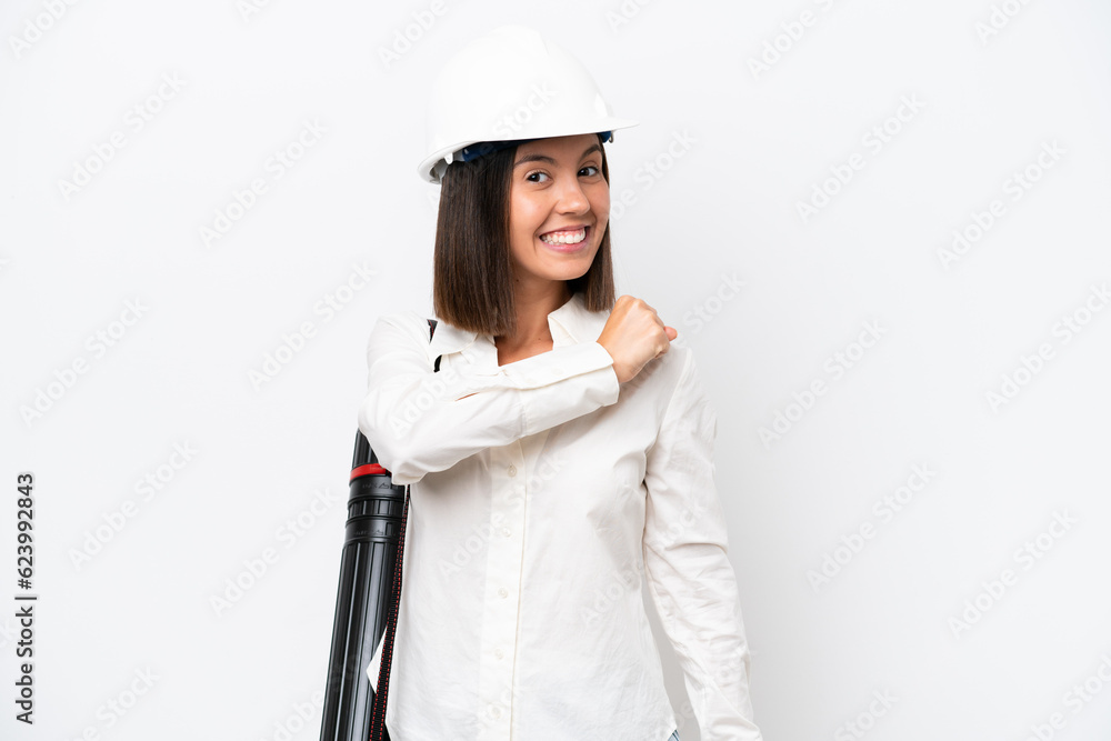 Young architect woman with helmet and holding blueprints isolated on white background celebrating a victory Young architect woman with helmet and holding blueprints isolated on white background celebrating a victory