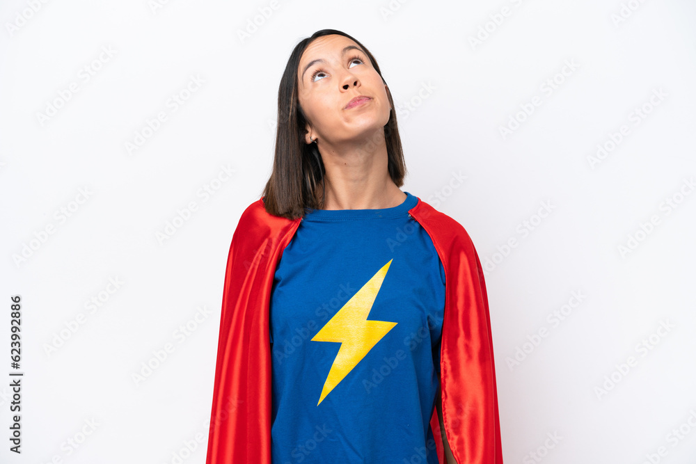 Super Hero caucasian woman isolated on white background and looking up