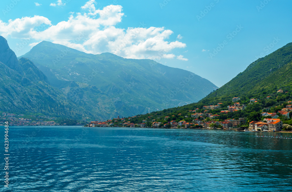 seascapes, a view of the Bay of Kotor during a cruise on a ship in Montenegro, a bright sunny day, mountains and small towns on the coast, the concept of a summer trip