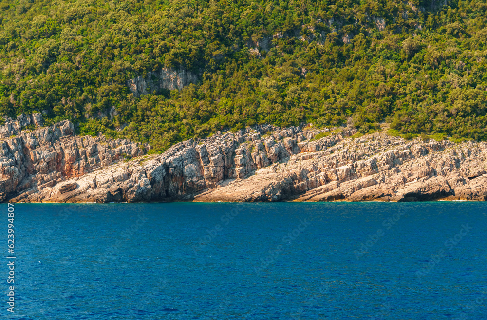seascapes, a view of the rocks and a sea cave on the Bay of Kotor during a cruise on a ship in Montenegro, a bright sunny day, the concept of a summer trip