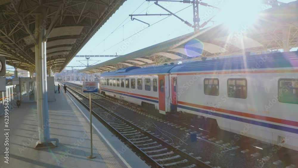 4K drone shooting from empty train station with sun shining from above. Passenger trains waiting for departure at platform stock video. 4K drone shooting from empty train station with sun shining from above. Passenger trains waiting for departure at platform stock video.