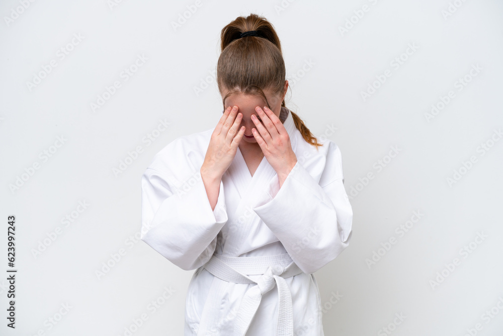 Young caucasian girl doing karate isolated on white background with tired and sick expression Young caucasian girl doing karate isolated on white background with tired and sick expression