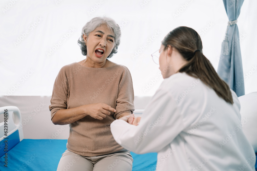 Fototapeta premium Physical injury treatment: Serious doctors are analyzing fracture patients. elderly with broken arm talking to trauma doctor or orthopedic surgeon during physical examination in hospital or clinic.