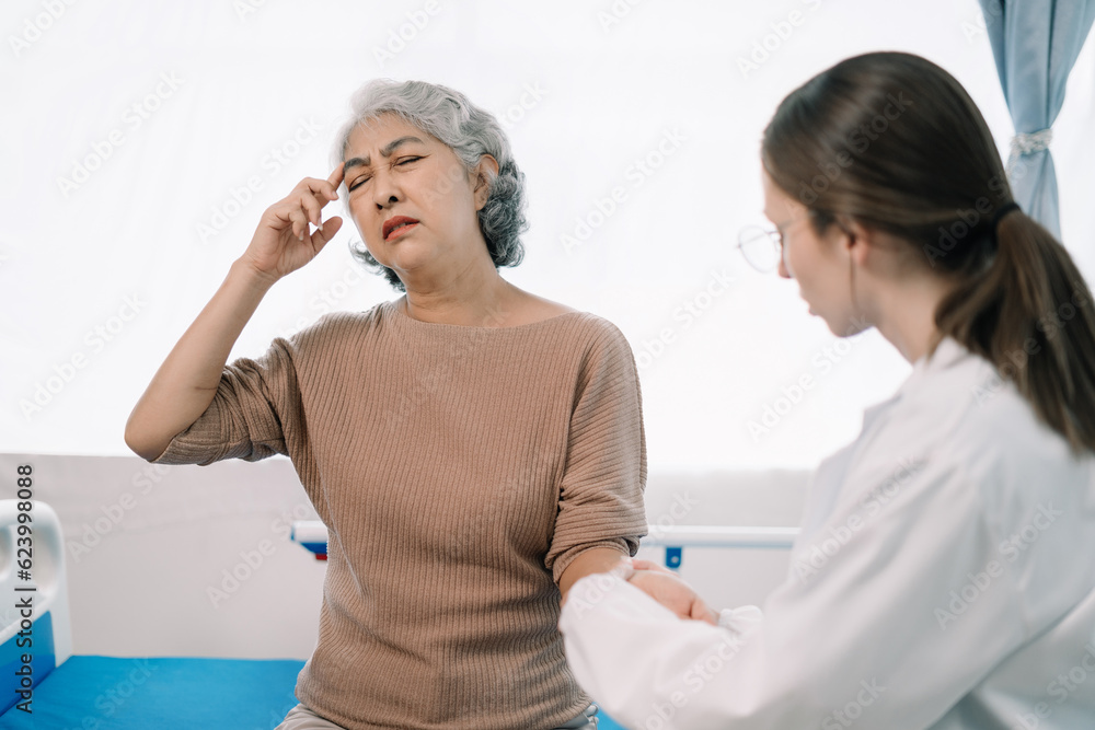Fototapeta premium Physical injury treatment: Serious doctors are analyzing fracture patients. elderly with broken arm talking to trauma doctor or orthopedic surgeon during physical examination in hospital or clinic.