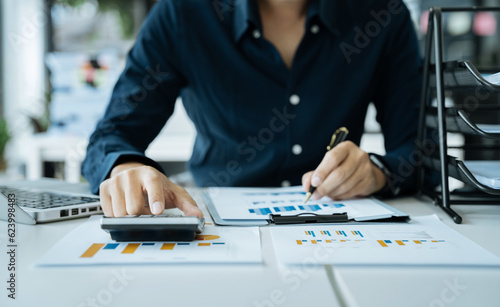 Male businessman and financial concepts about office work. Analysts discuss business with tablet and calculator as a tool.
