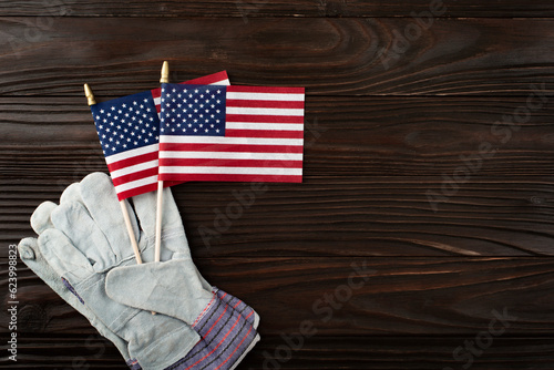 Labor day background of protective gloves and us flag on wooden planks photo