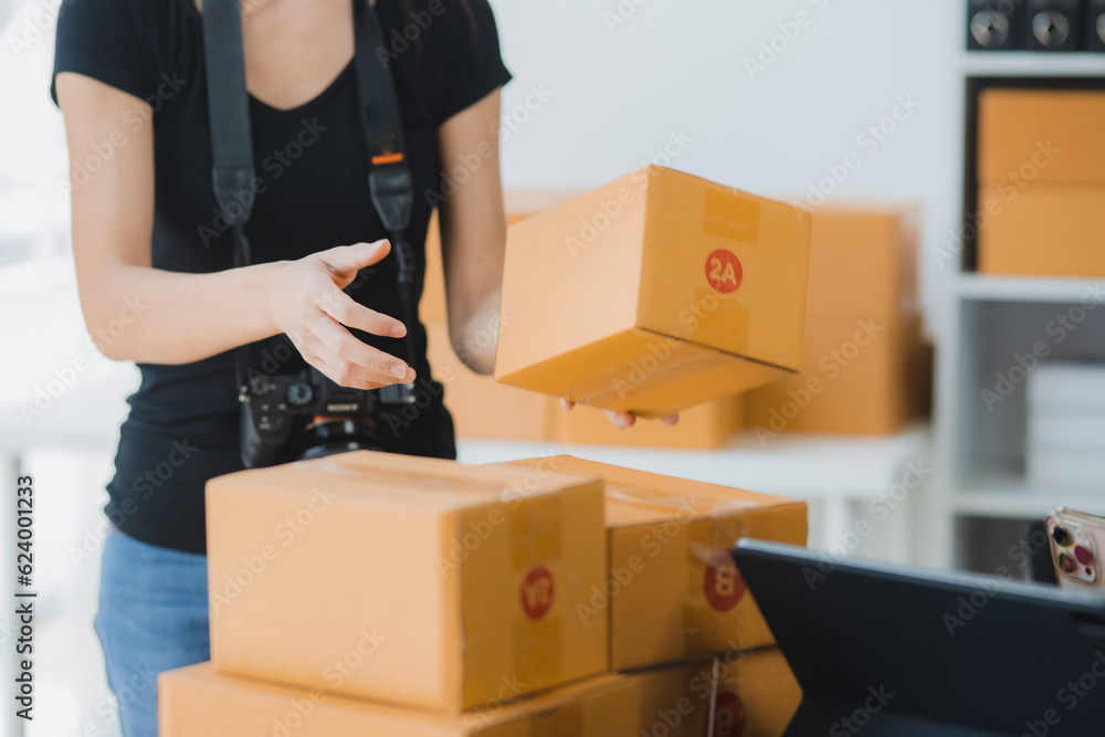 Businesswoman hands checking customer order online shipping boxes at desk, Online orders of product for deliver to customer and Shopping Online concept. Businesswoman hands checking customer order online shipping boxes at desk, Online orders of product for deliver to customer and Shopping Online concept.