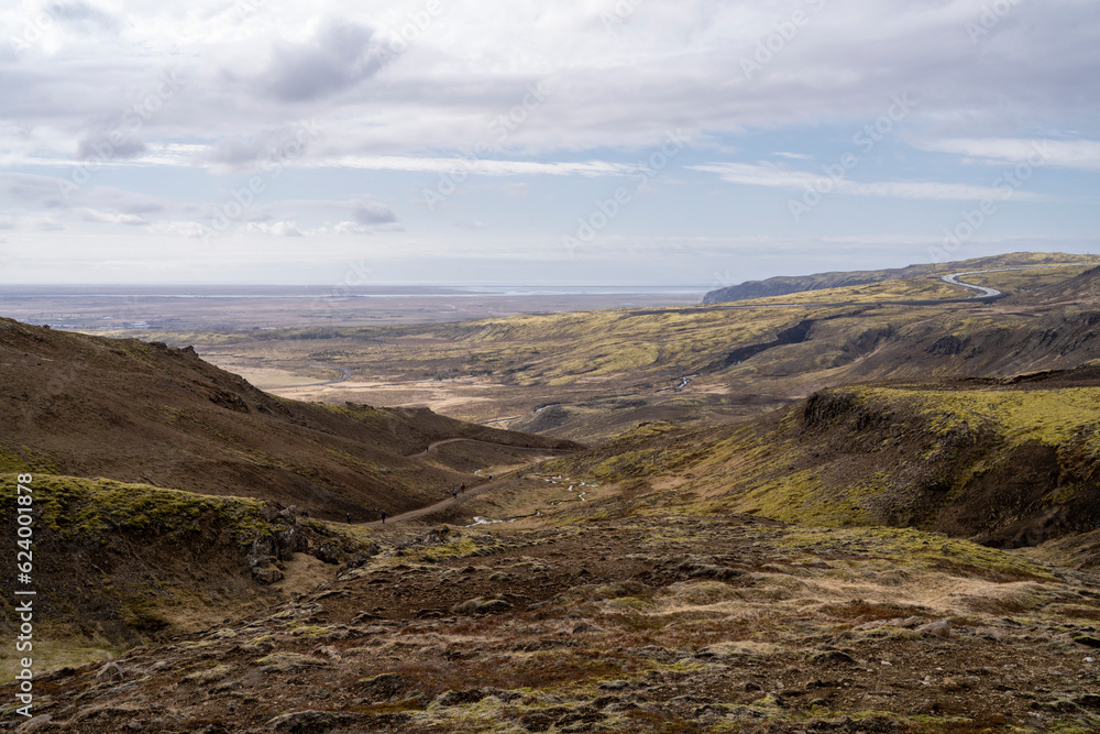 Reykjadalur Valley Cliff lookout over South Iceland and Hveragerdi City from above during daytime in the Early summer.