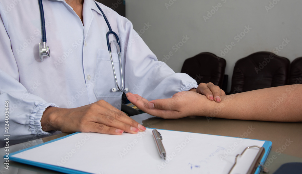 Medicine doctor do physical exam patient's wrist pulse in examination room hospital. Medicine doctor do physical exam patient's wrist pulse in examination room hospital.