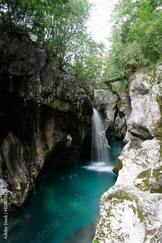 Beautiful waterfall in the big gorge rock cliffs of emerald soca river