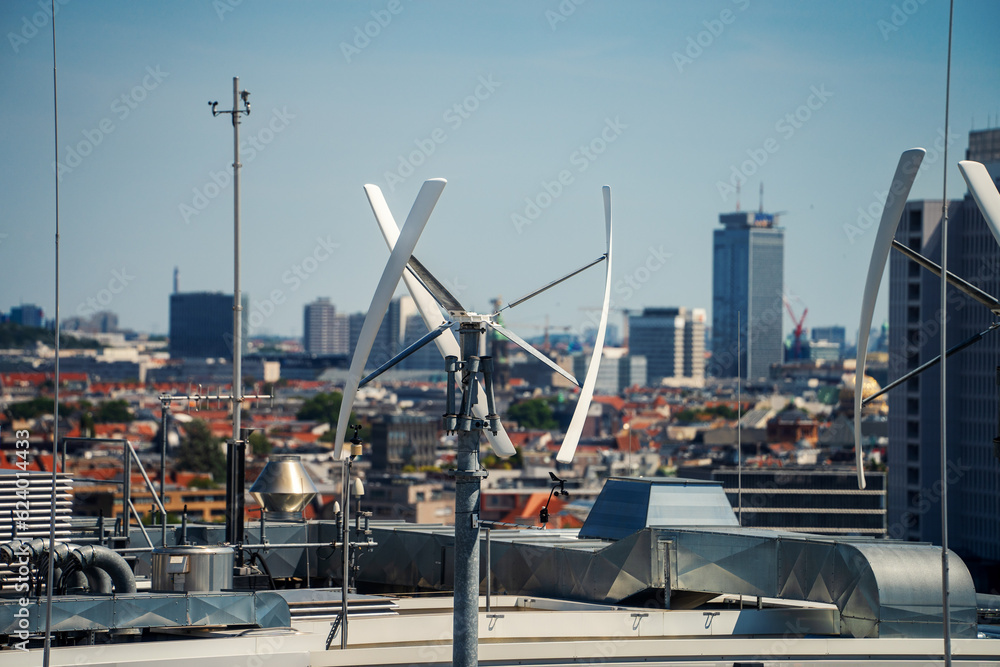 Vertical-axis wind turbine generating renewable energy on a rooftop in Berlin, Germany