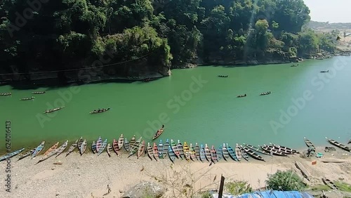 traditional wood boat for tourist parked at river edge at day photo