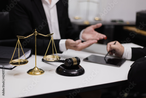 Male lawyer working with contract at desk, justice and law concept.