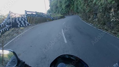 motorcycle rider view of different mountain curvy road landscape at day photo