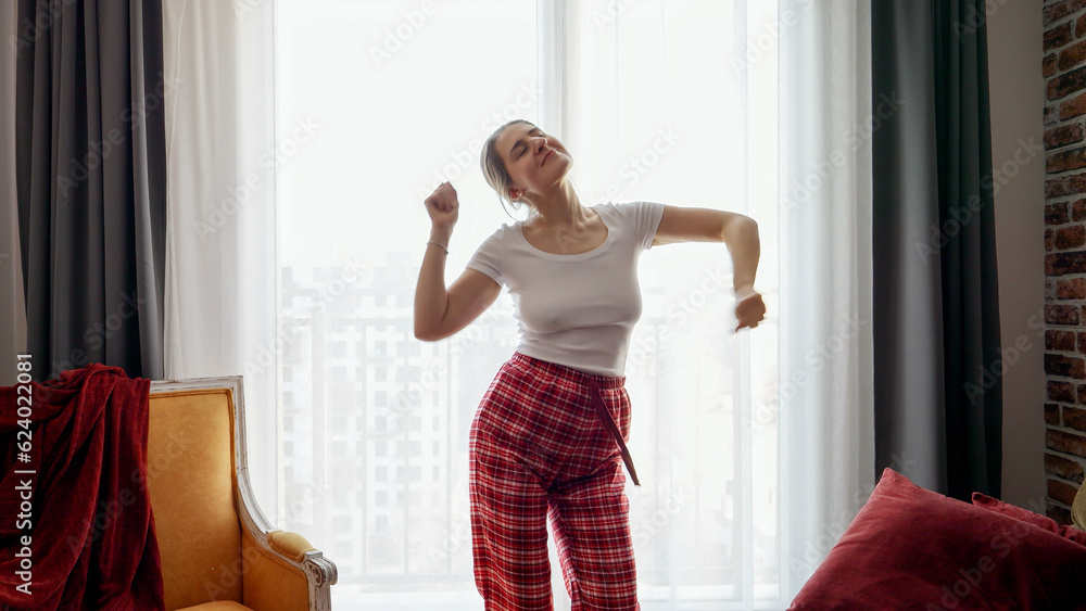 Portrait of happy smiling woman dancing at home in morning. People relaxing at home, having fun, positive emotions and fun. Portrait of happy smiling woman dancing at home in morning. People relaxing at home, having fun, positive emotions and fun.