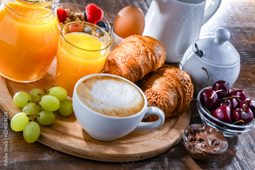 Breakfast served with coffee, orange juice, croissants and egg