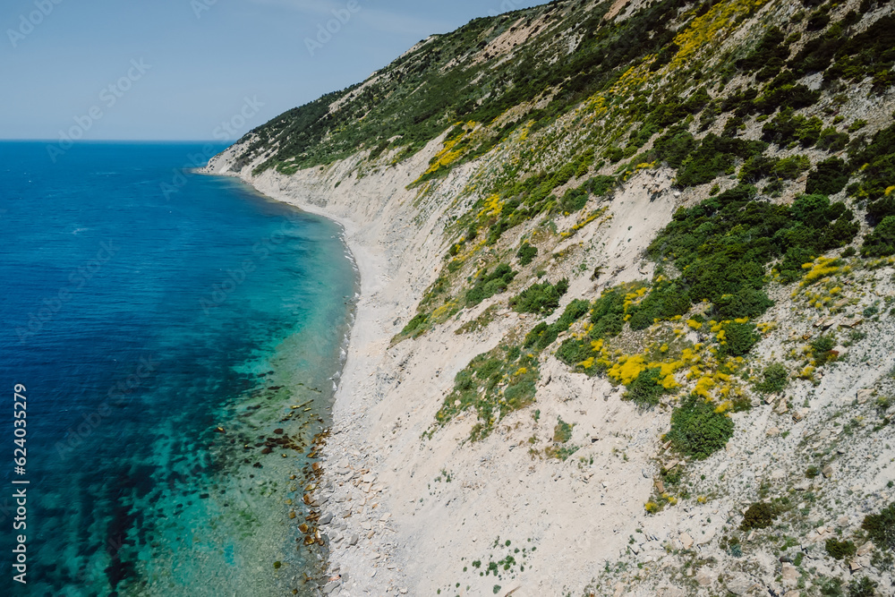 Coastline with blue sea and cliffs on coastline. Summer day on Mediterranean sea. Aerial view