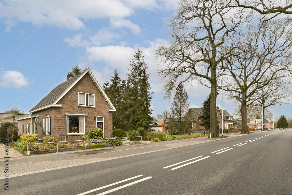 a street with houses and trees in the middle part of the photo is taken on a sunny, clear day