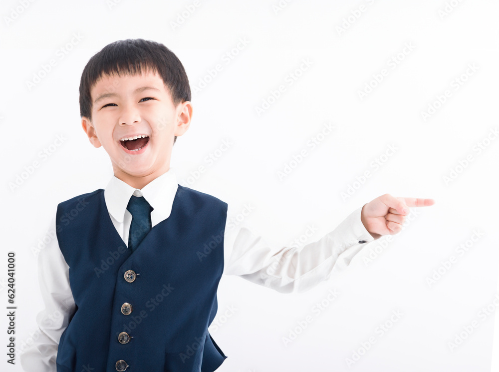 Happy boy pointing finger away at copy space Happy boy pointing finger away at copy space
