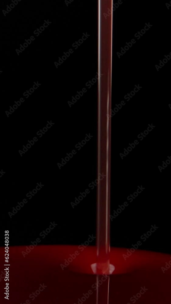I pour red syrup on a golden spoon. Dolly slider extreme close-up. Laowa Probe Vertical video. I pour red syrup on a golden spoon. Dolly slider extreme close-up. Laowa Probe Vertical video.