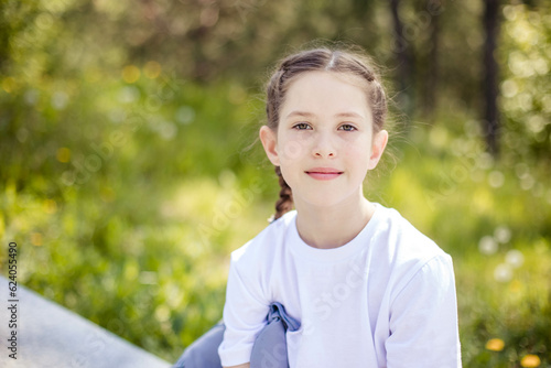 Close-up portrait of cute teenage girl smiling, looking at the camera. Copy space