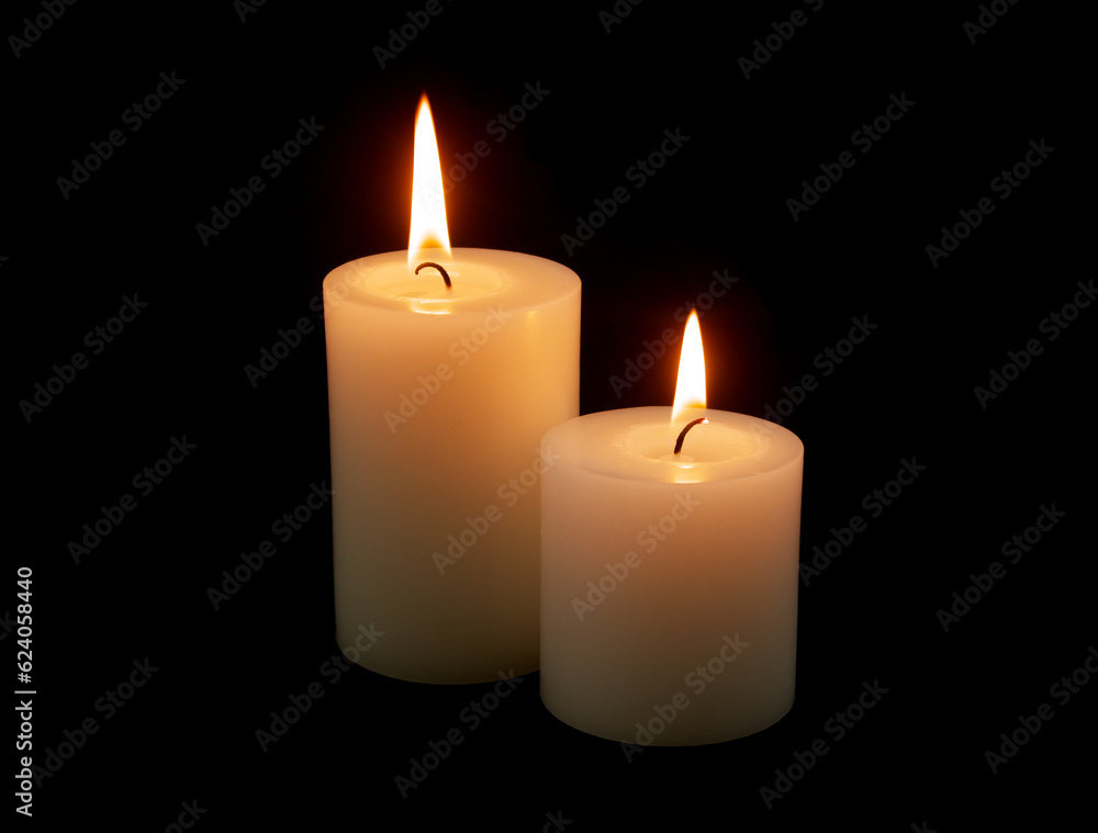 Two white candles burning on black background. Two white candles burning on black background.