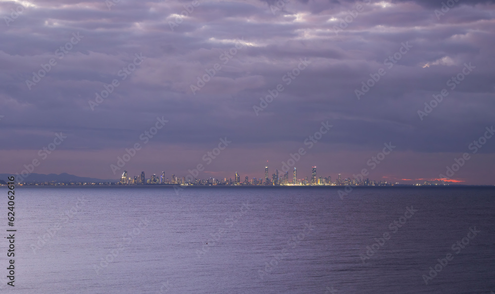 Sunset city lights view of the Gold Coast skyline seen from Coolangatta Beach, Queensland