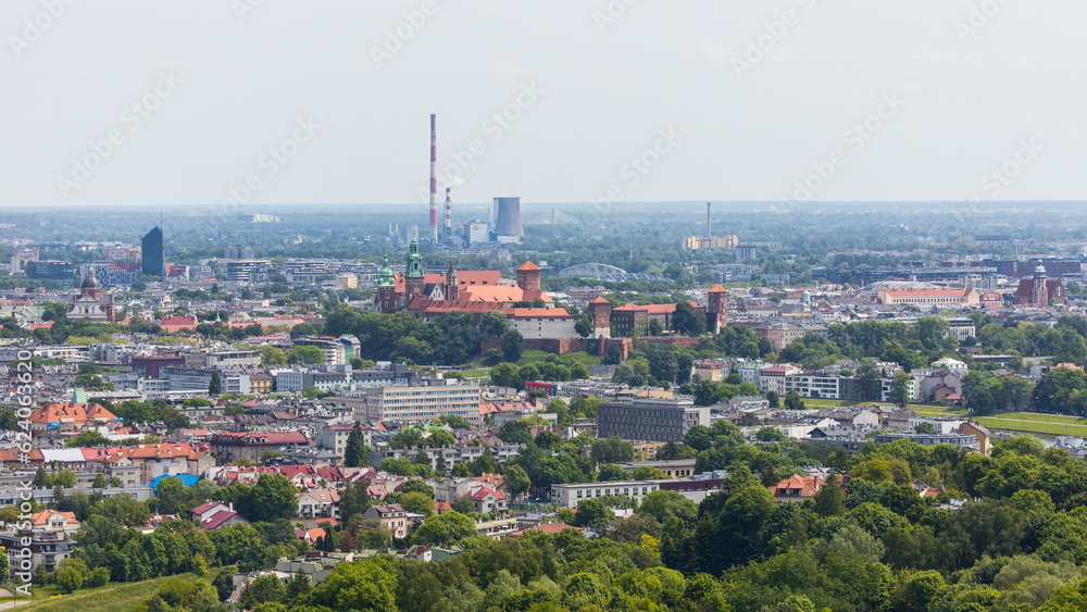 View over the historic city centre of Krakow with industrial plants and smokestacks in the background