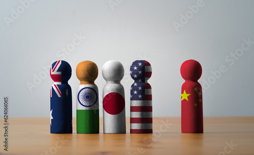 USA China Japan India and Australia flag print screen on wooden block cube for QUAD or Quadrilateral Security Dialogue concept. photo