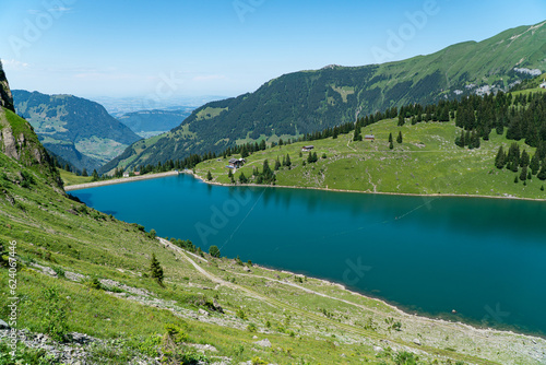 view of beautiful Bannalpsee a reservoir surrounded by mountains in the Swiss alps  Walenpfad