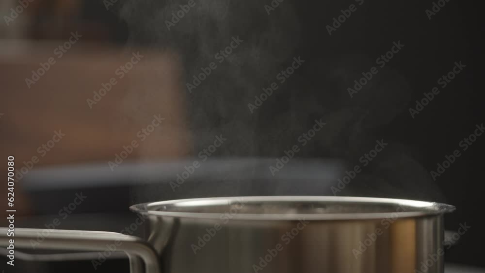 Slow motion steam rising from saucepan closeup Slow motion steam rising from saucepan closeup