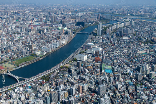 Aerial view of Sumida City and Taito City wards along the Sumida River in Tokyo Japan with a view over the residential and business areas photo