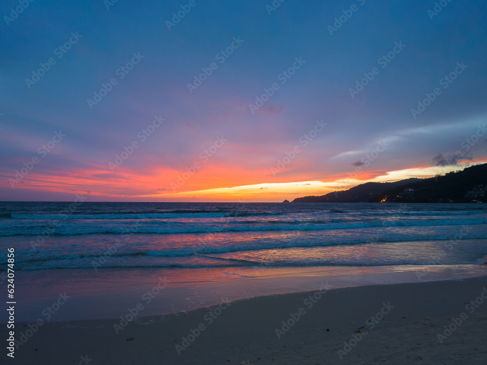 Obraz premium The sky changes color from yellow to red as the sun sets over the sea..sunset landscape amazing light of nature cloudscape sky. .Big sun and red lighting sky background. 4k resolution