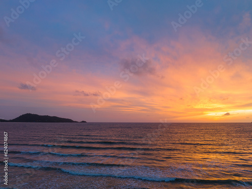 The sky changes color from yellow to red as the sun sets over the sea..sunset landscape amazing light of nature cloudscape sky. .Big sun and red lighting sky background. 4k resolution