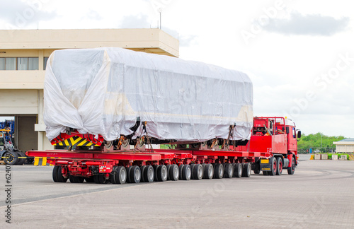 Transport of Oversize Heavy Machinery cargo truck Loading a new locomotive port area