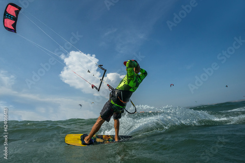 A kite surfer rides the waves