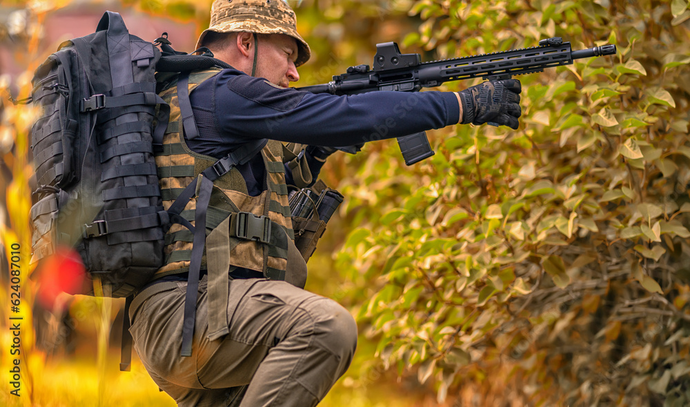 Warrior takes aim from his rifle from a seated position