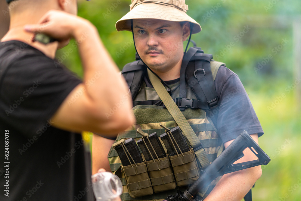 Two soldiers communicate outdoors