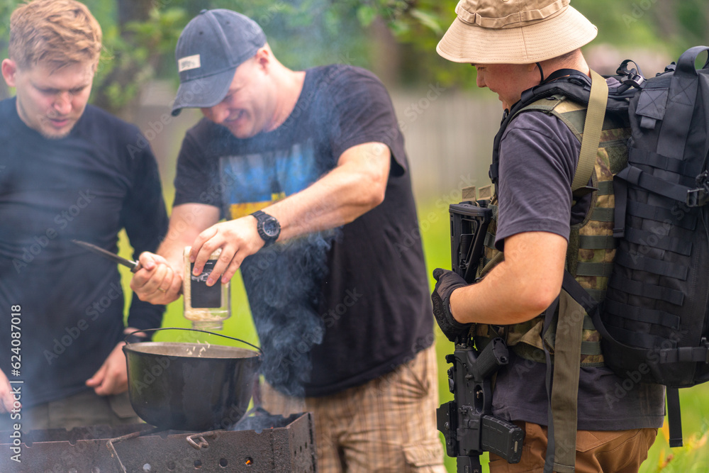 Three soldiers preparing lunch in the field