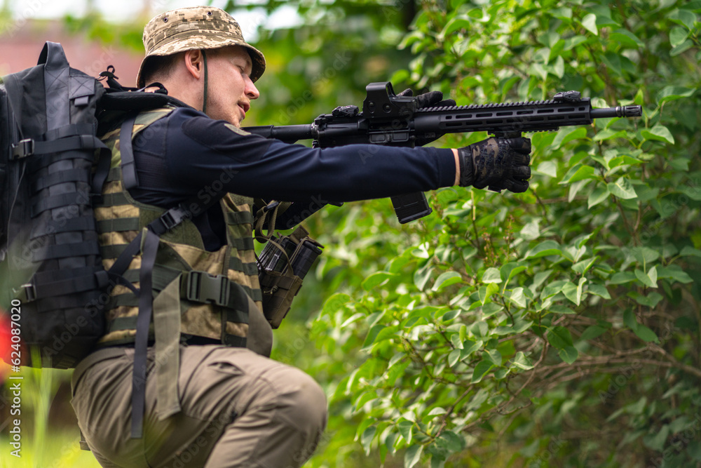 Soldier testing the grip on his rifle