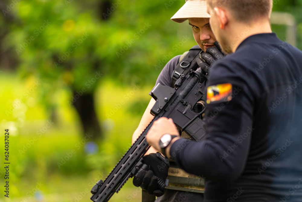 Man with a gun looking at the camera