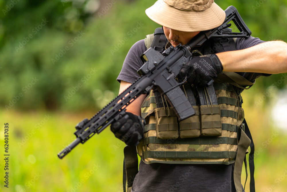 Armed man checks the functionality of the scope