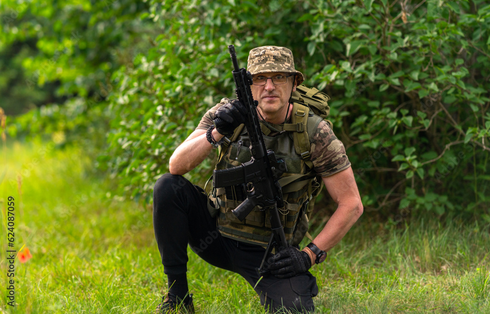 Soldier or mercenary crouching on one leg, looking at the camera